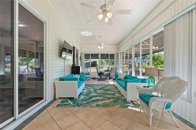 sunroom featuring ceiling fan