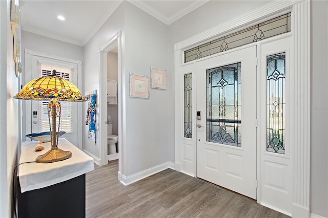 entryway featuring hardwood / wood-style flooring and ornamental molding