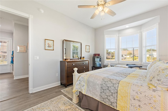 bedroom with ceiling fan and hardwood / wood-style floors