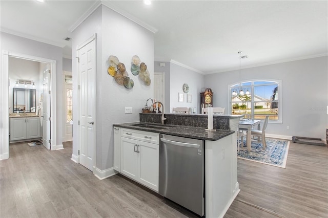 kitchen with sink, white cabinetry, dark stone countertops, dishwasher, and pendant lighting