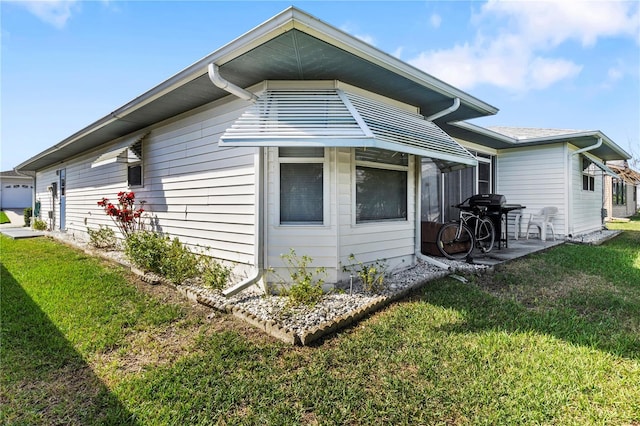 view of side of home featuring a yard