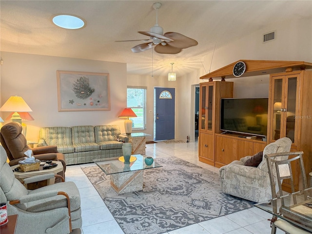 tiled living room with vaulted ceiling, ceiling fan, and visible vents