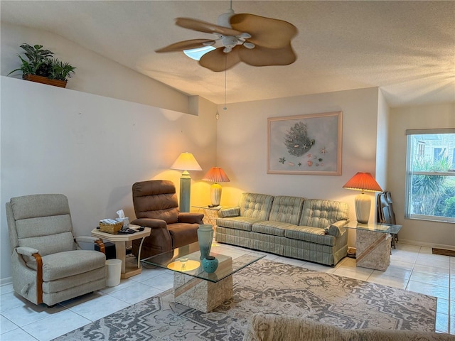 tiled living room with baseboards, vaulted ceiling, and a ceiling fan
