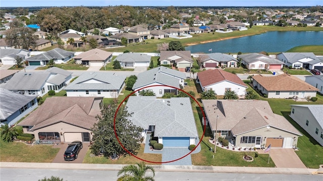drone / aerial view featuring a residential view and a water view
