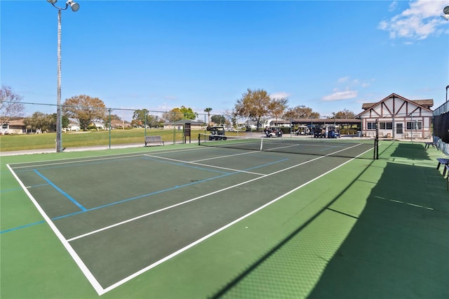 view of tennis court featuring fence