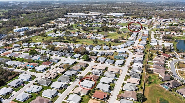 birds eye view of property with a residential view and a water view
