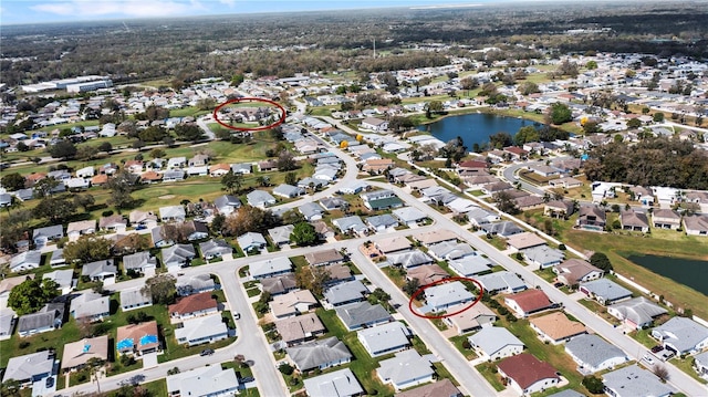 birds eye view of property with a water view and a residential view