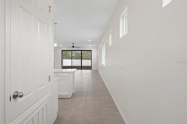 corridor featuring light tile patterned floors