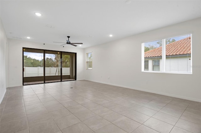 unfurnished room featuring ceiling fan and light tile patterned flooring