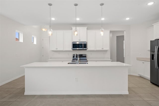 kitchen with decorative light fixtures, white cabinetry, stainless steel appliances, and an island with sink