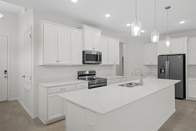 kitchen featuring sink, white cabinets, a kitchen island with sink, and appliances with stainless steel finishes