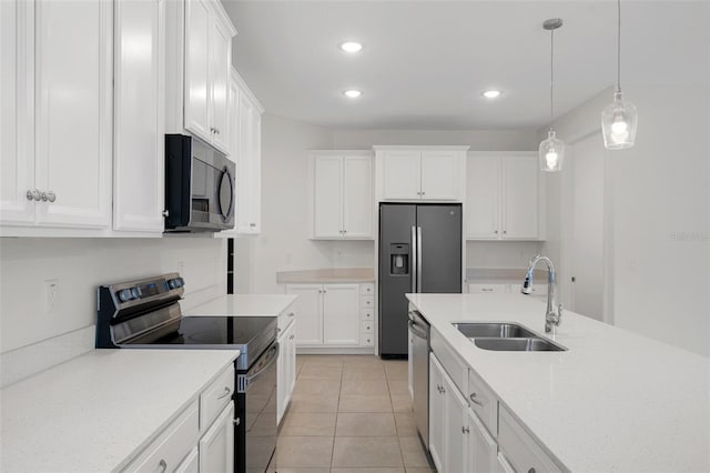 kitchen featuring white cabinetry, hanging light fixtures, sink, stainless steel appliances, and light tile patterned flooring