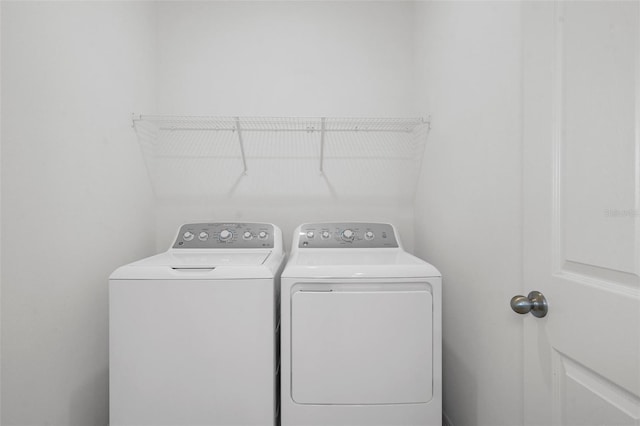 laundry room with washing machine and clothes dryer