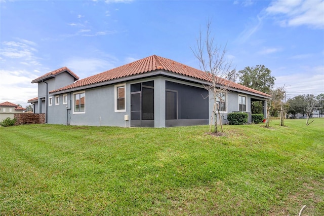 rear view of house featuring a yard