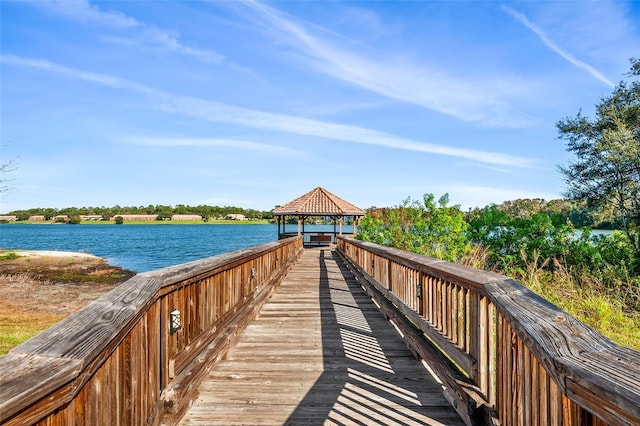 view of dock featuring a gazebo and a water view