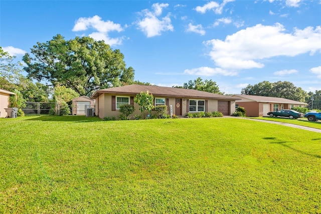 ranch-style home with an attached garage, central AC, fence, concrete driveway, and a front yard