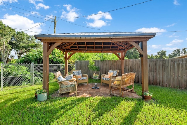 view of yard featuring a fenced backyard, outdoor lounge area, and a gazebo