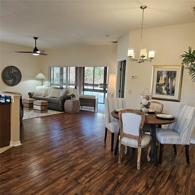 dining room with ceiling fan with notable chandelier and wood finished floors