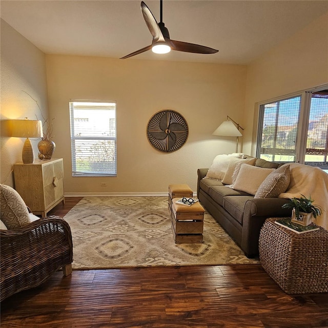 living area with a healthy amount of sunlight, ceiling fan, and wood finished floors