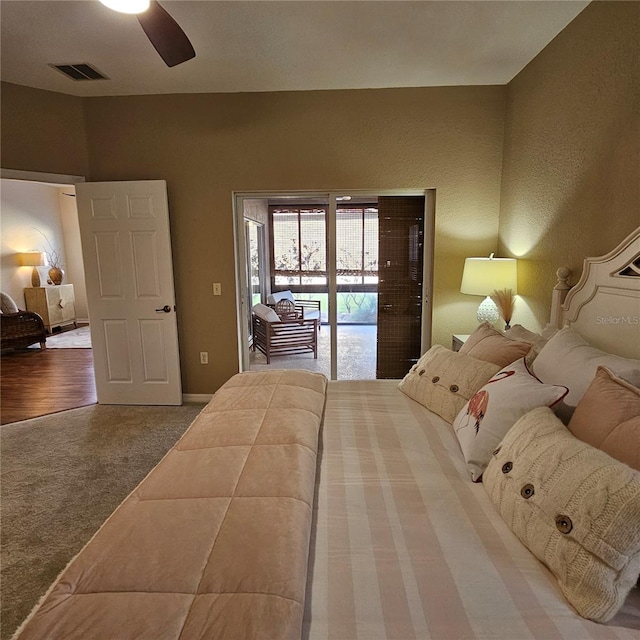 bedroom with access to exterior, a ceiling fan, visible vents, and carpet flooring