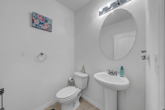 bathroom featuring sink, toilet, and tile patterned flooring