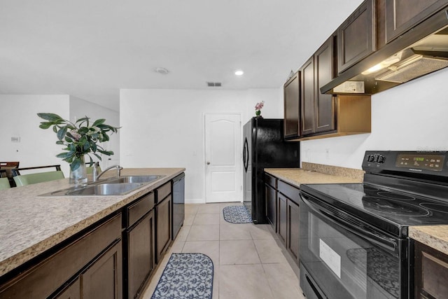 kitchen featuring black appliances, light tile patterned floors, sink, dark brown cabinetry, and wall chimney exhaust hood