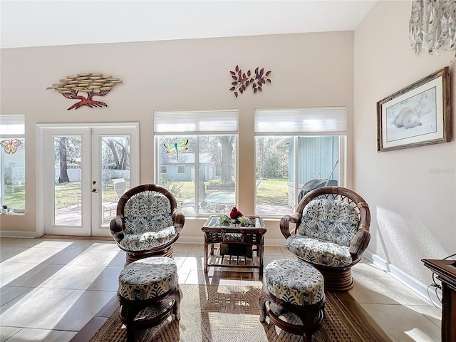 living area with light tile patterned flooring and french doors