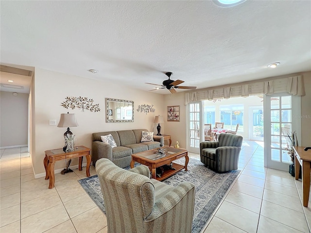 tiled living room featuring ceiling fan and a textured ceiling