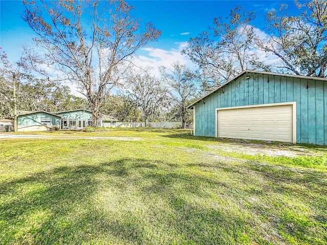 view of yard featuring a garage and an outdoor structure