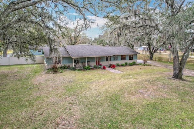 ranch-style home featuring a front yard