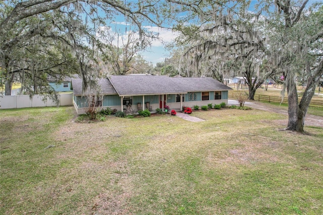 ranch-style home with roof with shingles and a porch