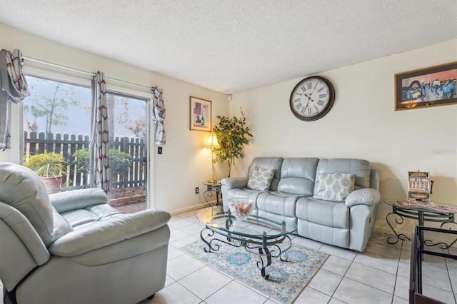 tiled living room featuring a textured ceiling