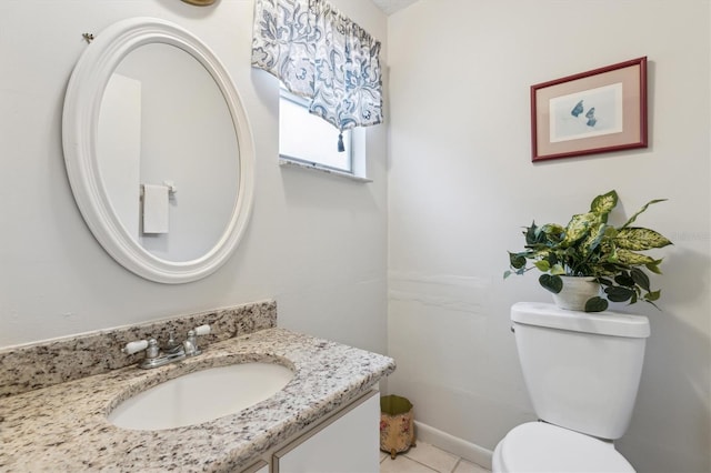 bathroom featuring vanity, tile patterned floors, and toilet