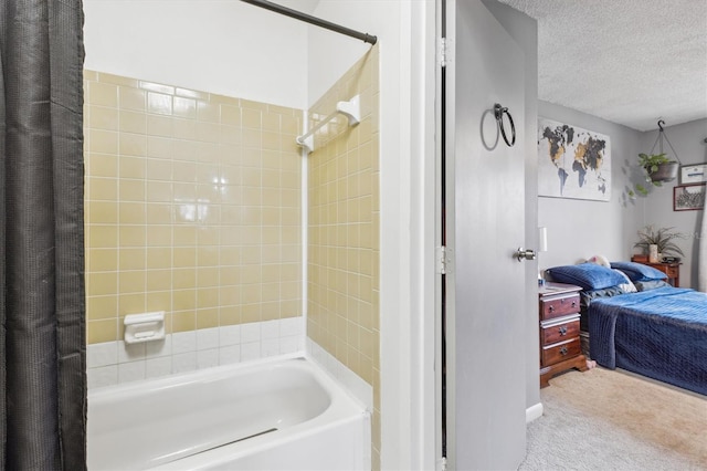 bathroom featuring shower / bath combination with curtain and a textured ceiling