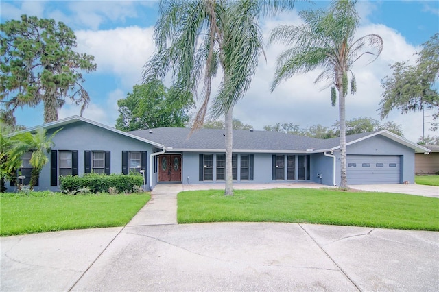 single story home with a garage and a front yard