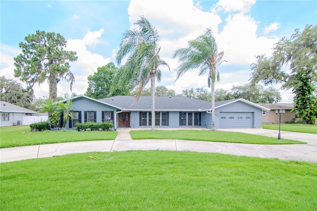 single story home featuring a garage and a front lawn