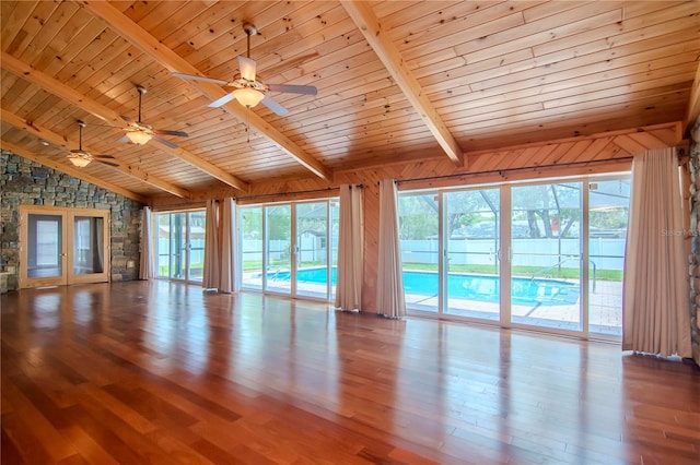 unfurnished living room with wooden ceiling, light wood-type flooring, vaulted ceiling with beams, and plenty of natural light