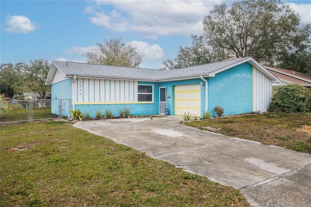 ranch-style home featuring a garage and a front lawn