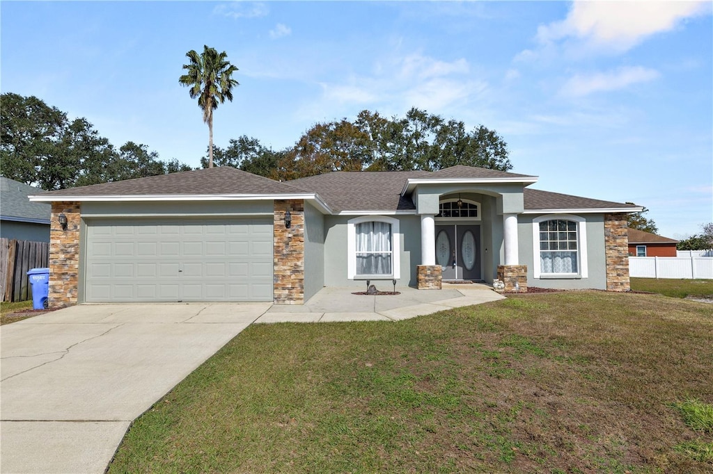 view of front of house featuring a garage and a front yard