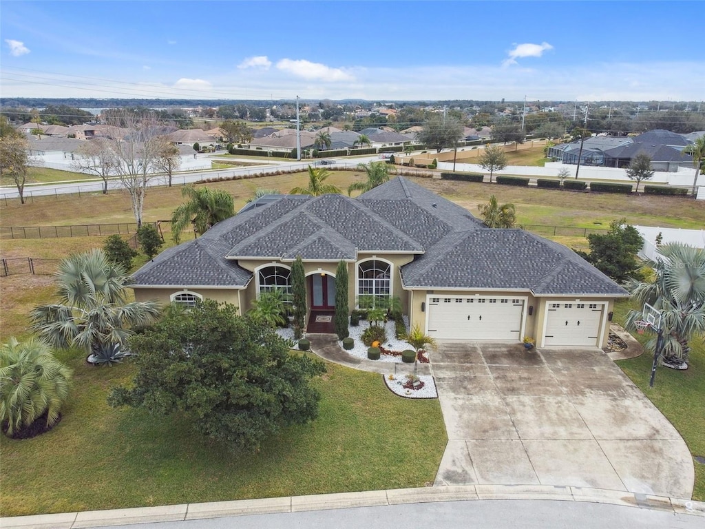 view of front of home featuring a garage and a front lawn