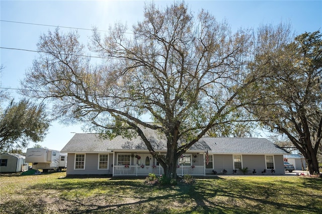 ranch-style house with a porch and a front lawn