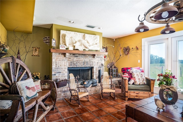 tiled living room featuring a brick fireplace and a textured ceiling