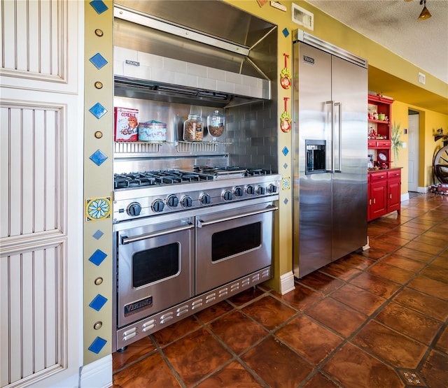 kitchen with a textured ceiling, extractor fan, and high quality appliances