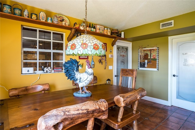 dining space featuring a textured ceiling