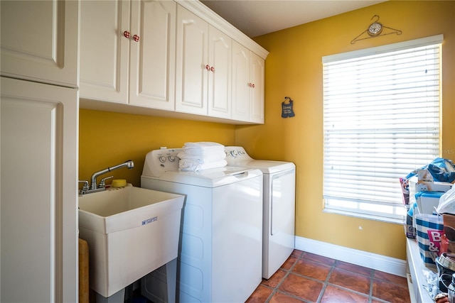 washroom with washer and dryer, sink, dark tile patterned flooring, and cabinets