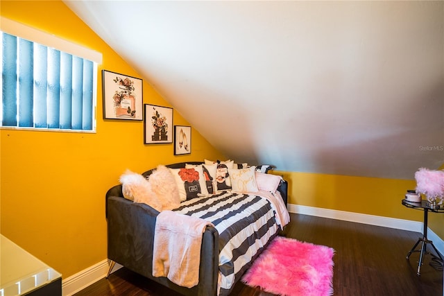 bedroom featuring vaulted ceiling and dark hardwood / wood-style flooring