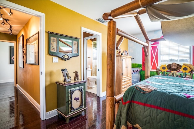 bedroom with ensuite bathroom and dark hardwood / wood-style flooring