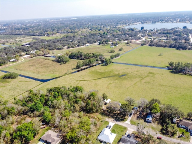 birds eye view of property featuring a water view and a rural view