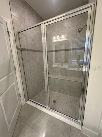 bathroom with tile patterned flooring and an enclosed shower