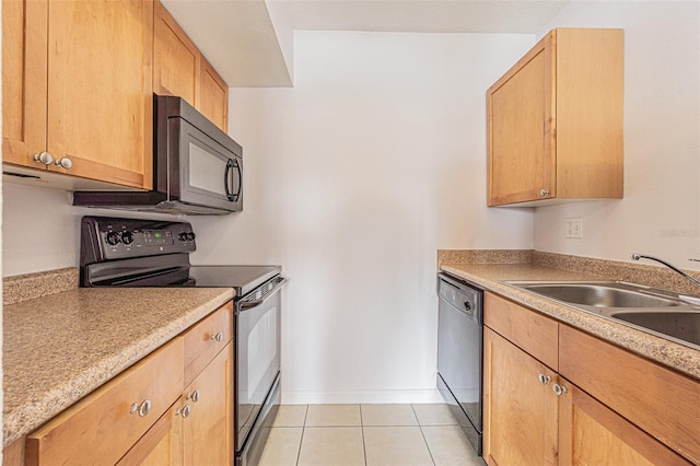 kitchen with sink, light tile patterned floors, light brown cabinetry, and black appliances